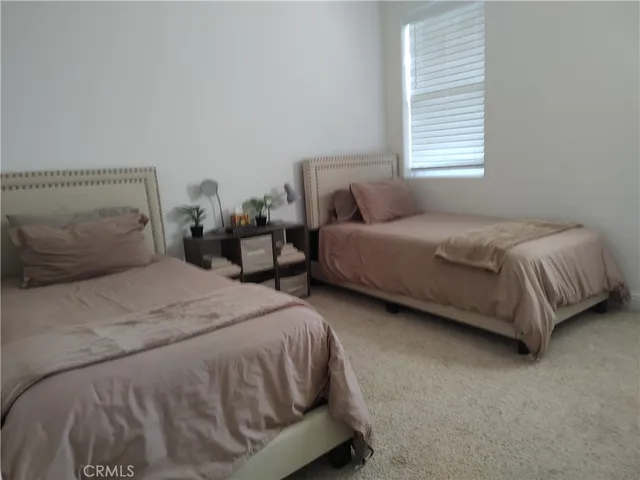 a bathroom with a granite countertop sink a mirror and a toilet