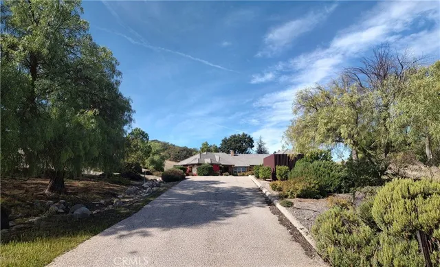 a view of a dry yard with wooden fence