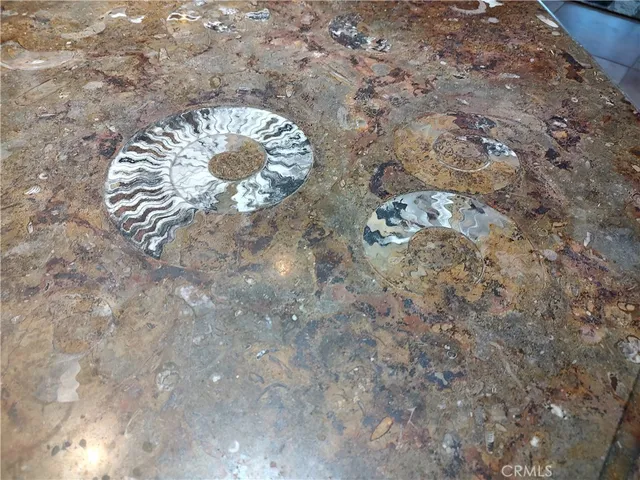 a living room with furniture kitchen view and a fireplace