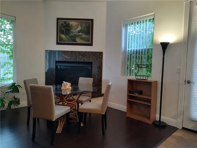 a living room with furniture a flat screen tv and a large window