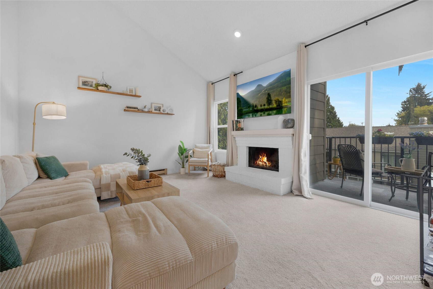 a bedroom with furniture a flat screen tv and a fireplace
