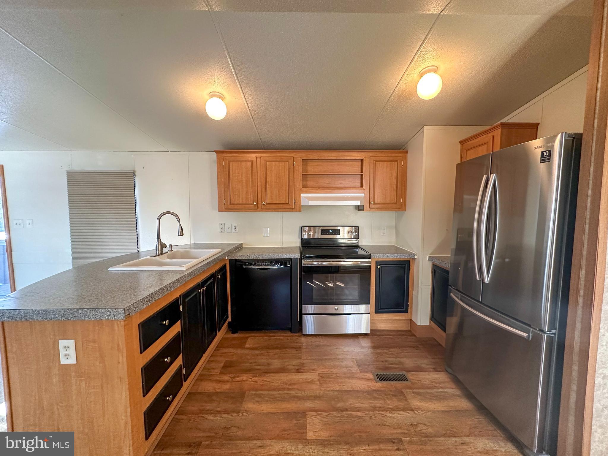 760 Azalea Lane Gap, PA 17527 - Photo 19 of 32 a kitchen with stainless steel appliances granite countertop a stove refrigerator and a sink
