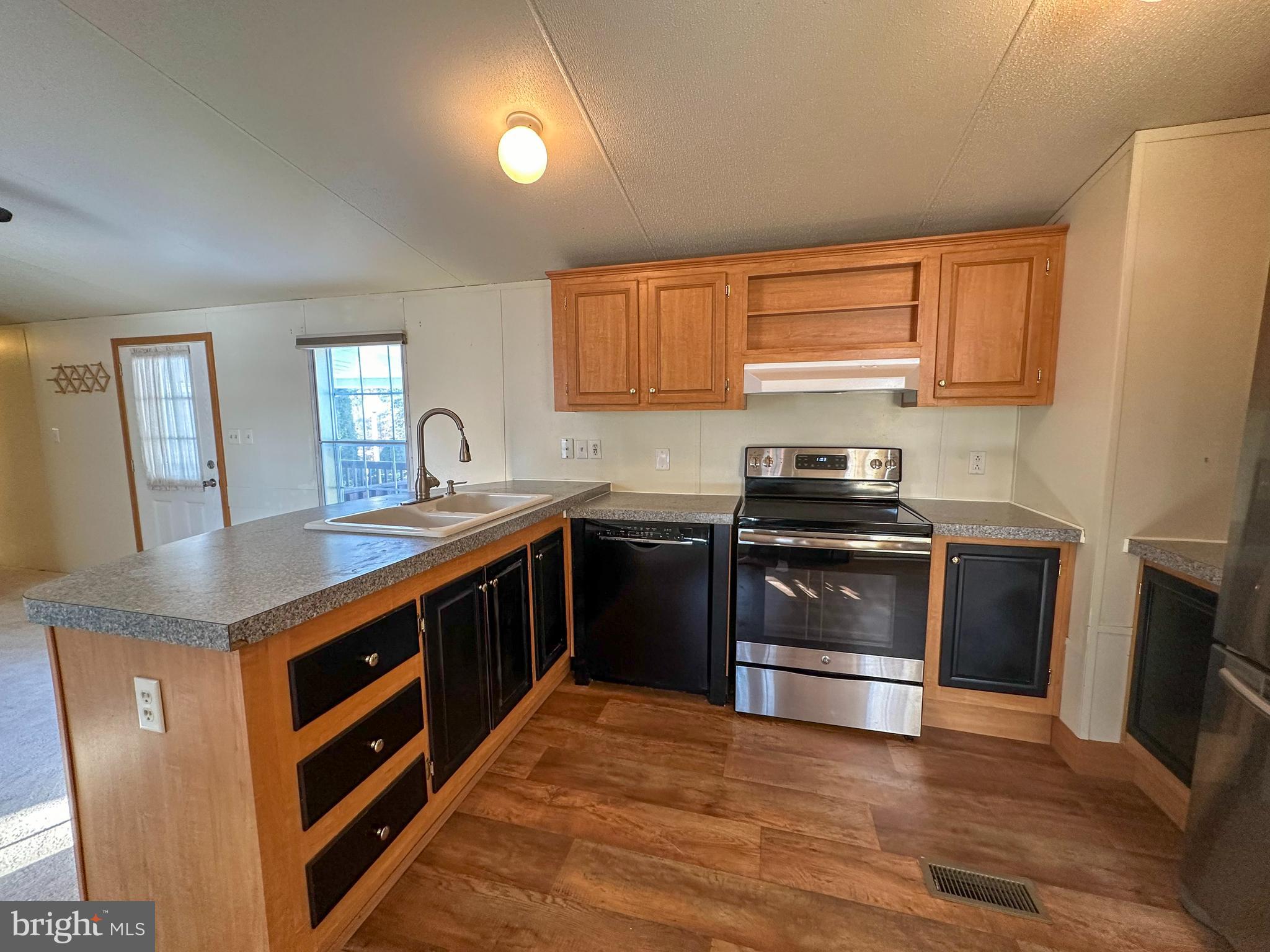 760 Azalea Lane Gap, PA 17527 - Photo 21 of 32 a kitchen with stainless steel appliances granite countertop a stove a sink and a refrigerator