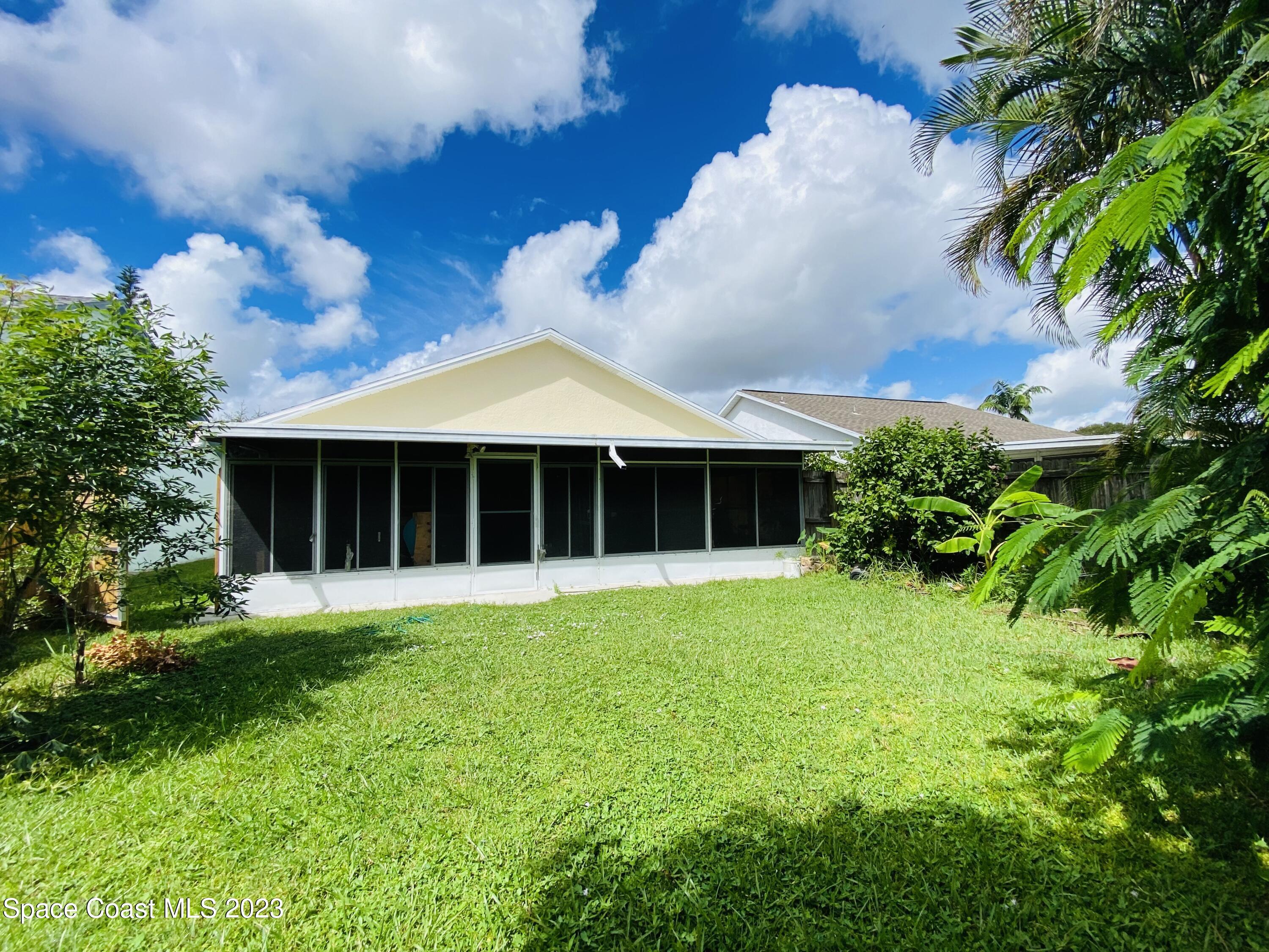3985 Bayberry Drive Melbourne, FL 32901 - Photo 13 of 13 a front view of a house with a yard and garage