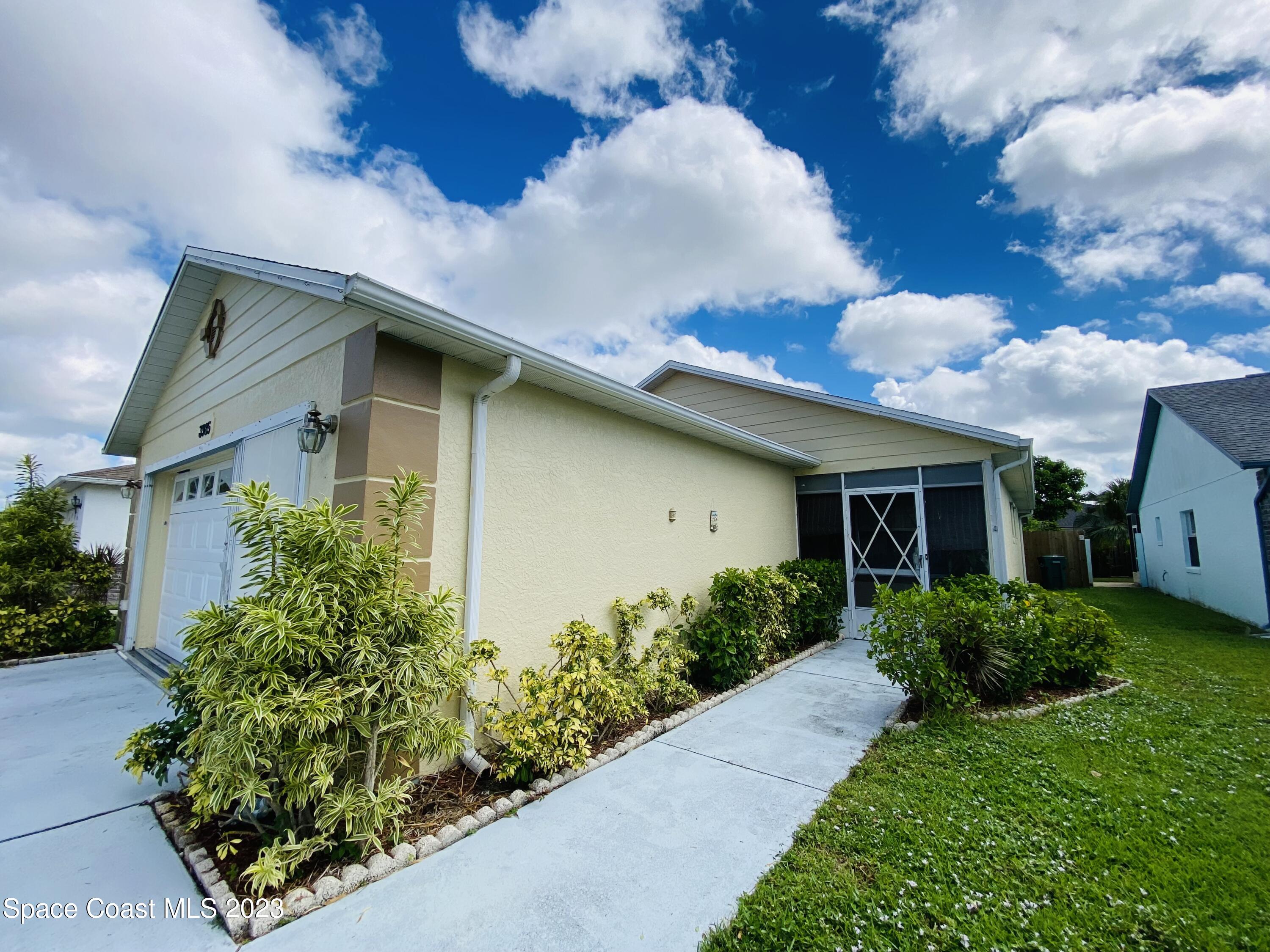 3985 Bayberry Drive Melbourne, FL 32901 - Photo 2 of 13 a front view of a house with garden