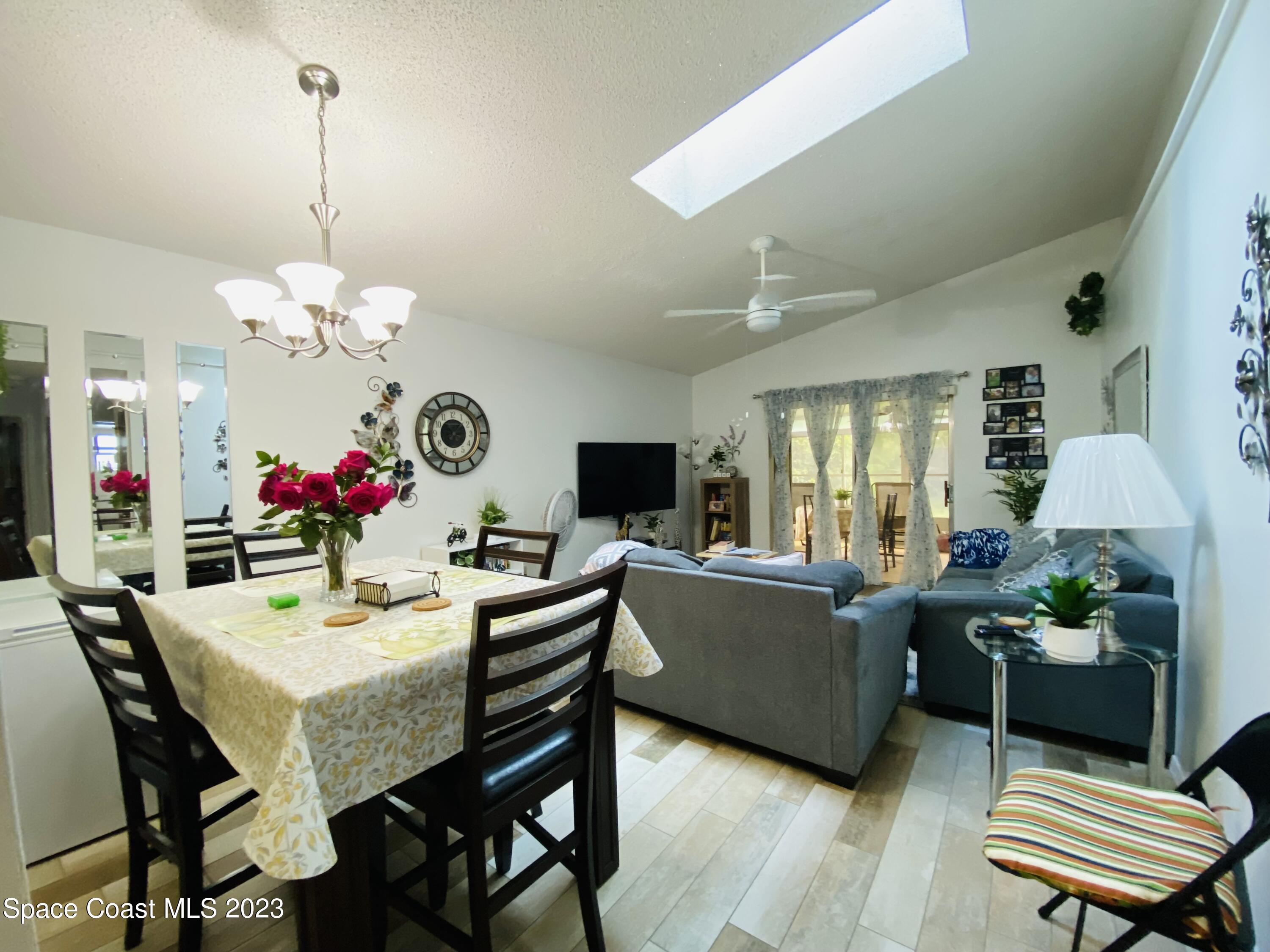 3985 Bayberry Drive Melbourne, FL 32901 - Photo 4 of 13 a view of a dining room with furniture and a chandelier
