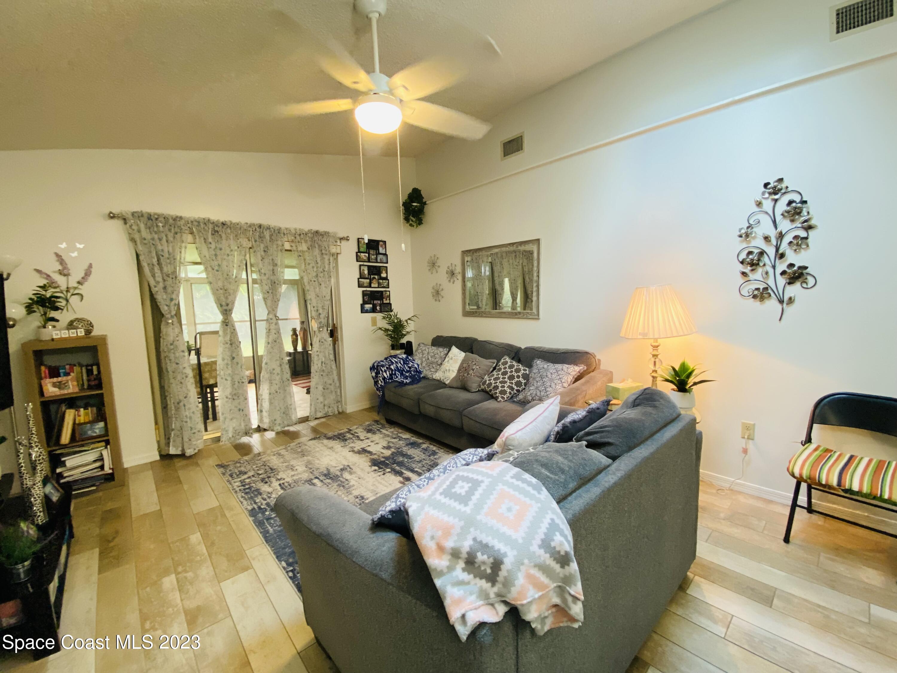 3985 Bayberry Drive Melbourne, FL 32901 - Photo 5 of 13 a living room with furniture and a chandelier
