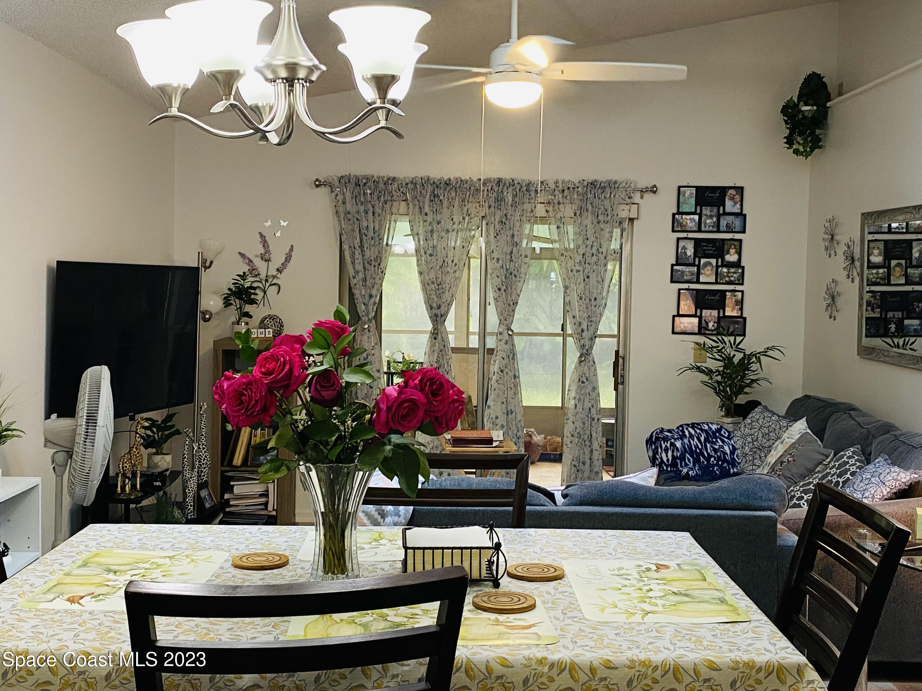 3985 Bayberry Drive Melbourne, FL 32901 - Photo 8 of 13 a view of a dining room with furniture and chandelier