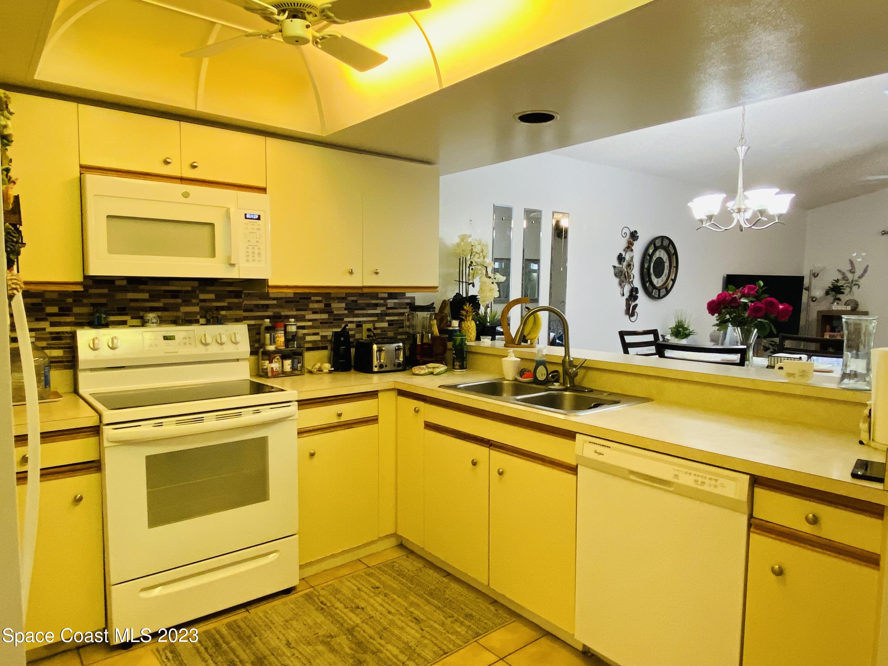 3985 Bayberry Drive Melbourne, FL 32901 - Photo 10 of 13 a kitchen with stainless steel appliances granite countertop a sink and cabinets