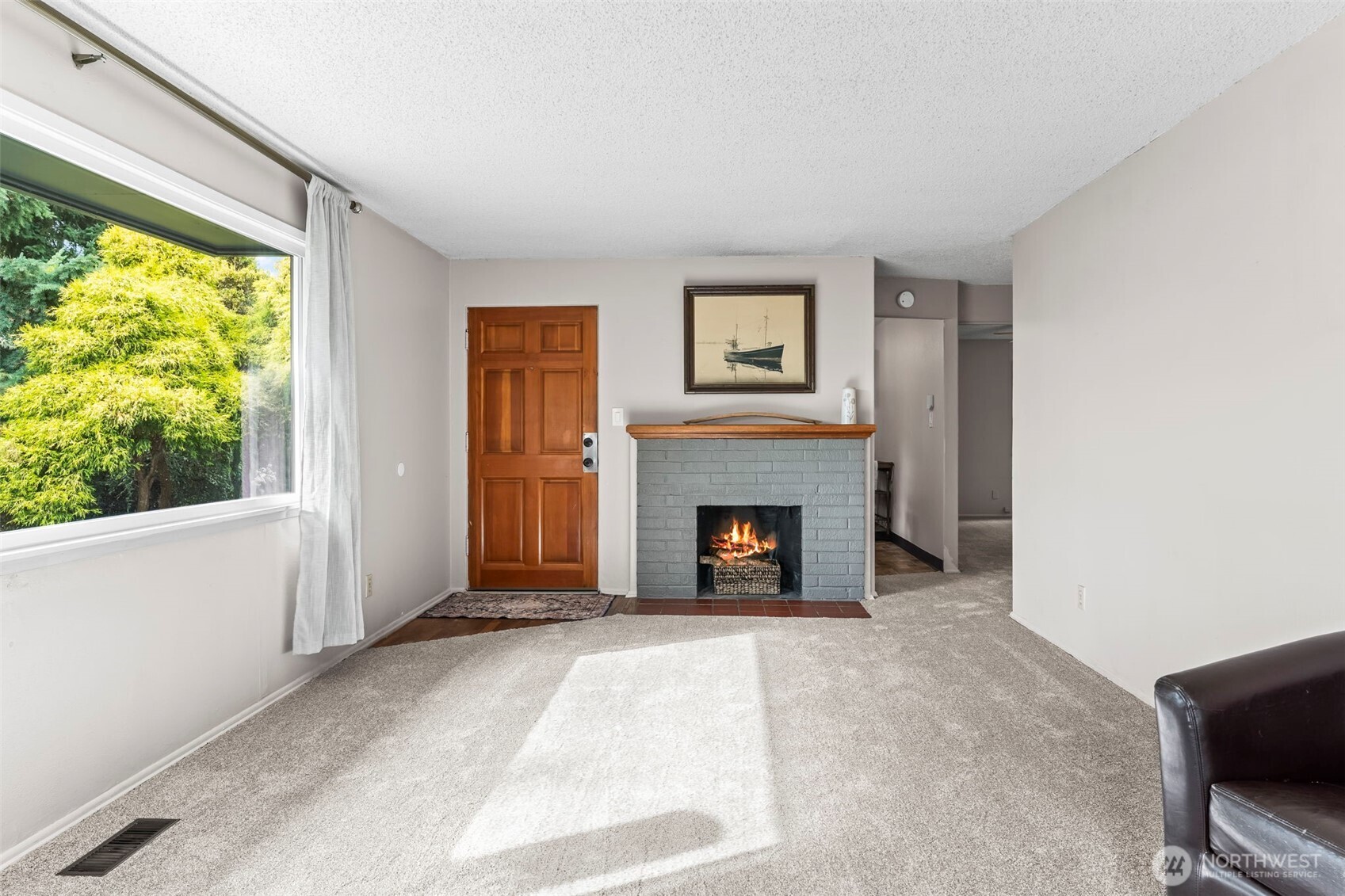 4403 Paradise Avenue West University Place, WA 98466 - Photo 13 of 35 a living room with a fireplace and a large window