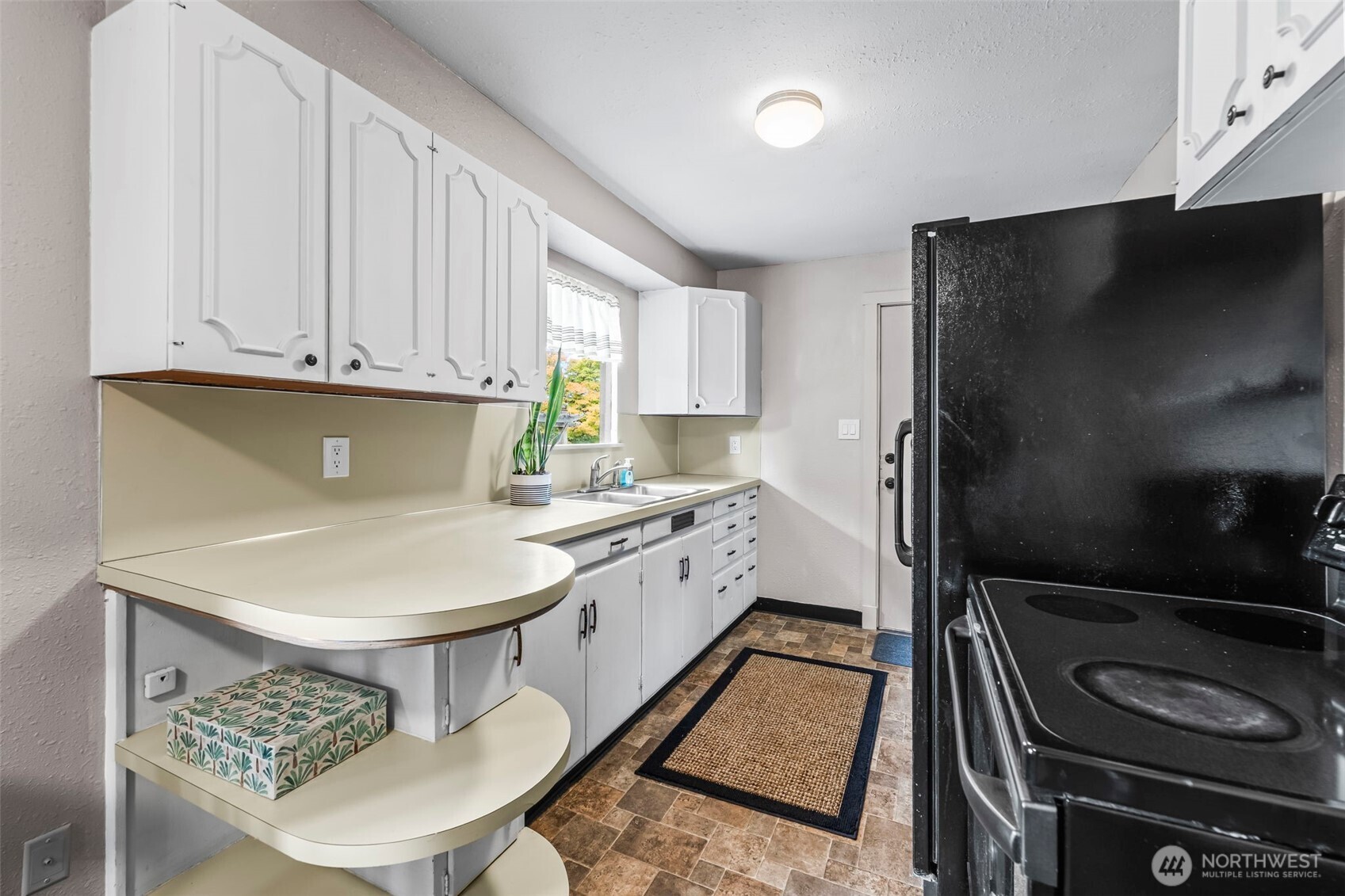 4403 Paradise Avenue West University Place, WA 98466 - Photo 18 of 35 a kitchen with a sink a stove and refrigerator