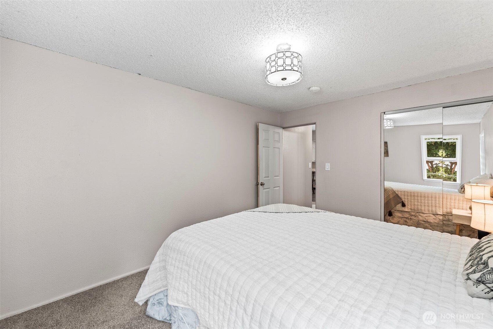 4403 Paradise Avenue West University Place, WA 98466 - Photo 23 of 35 a bedroom with a bed and a chandelier