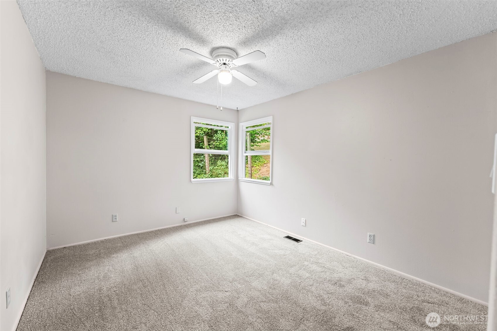 4403 Paradise Avenue West University Place, WA 98466 - Photo 24 of 35 an empty room with windows and chandelier fan