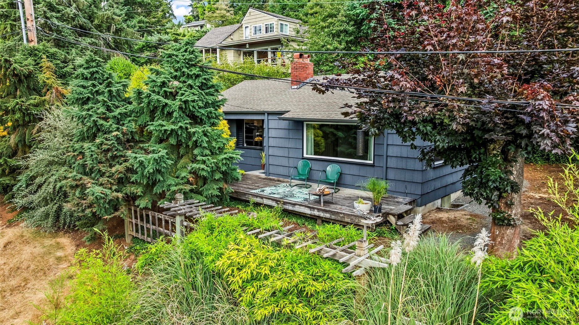 4403 Paradise Avenue West University Place, WA 98466 - Photo 7 of 35 a backyard of a house with table and chairs under an umbrella