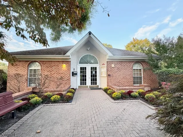 a front view of a house with large windows