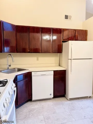 a kitchen with a cabinets and white refrigerator