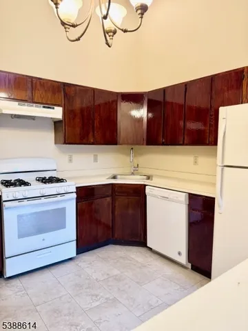 a kitchen with a cabinets and white appliances