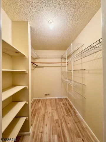 a view of a room with wooden floor and a window