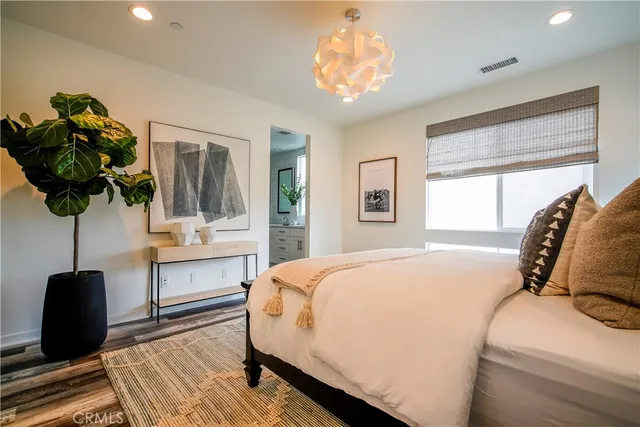 a bedroom with a bed potted plant with the window