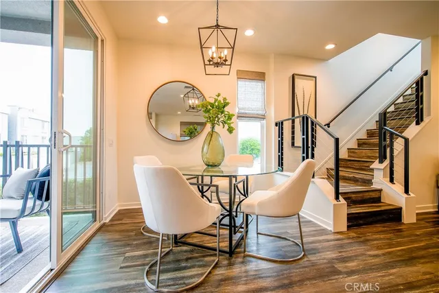 a dining room with wooden floor a glass table and chairs