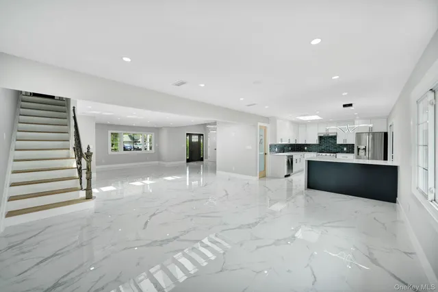 a view of kitchen with cabinets and refrigerator