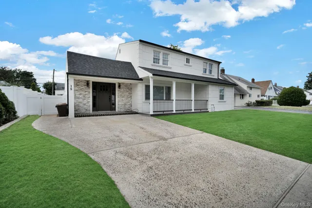 a view of a house with a yard and potted plants