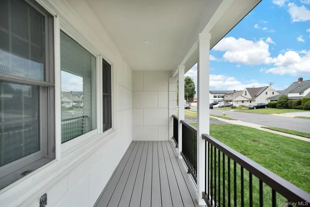 a view of a balcony with a yard