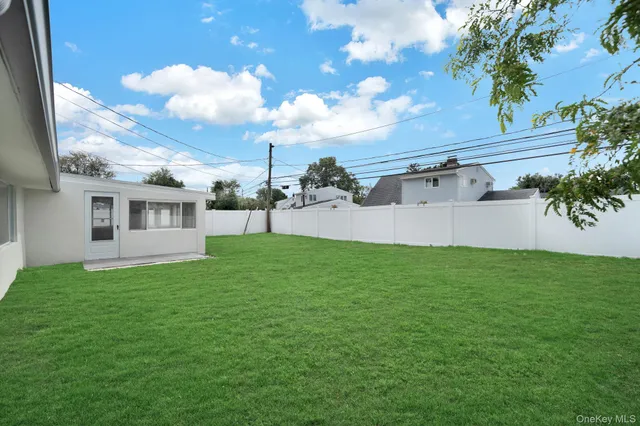 a view of house with backyard