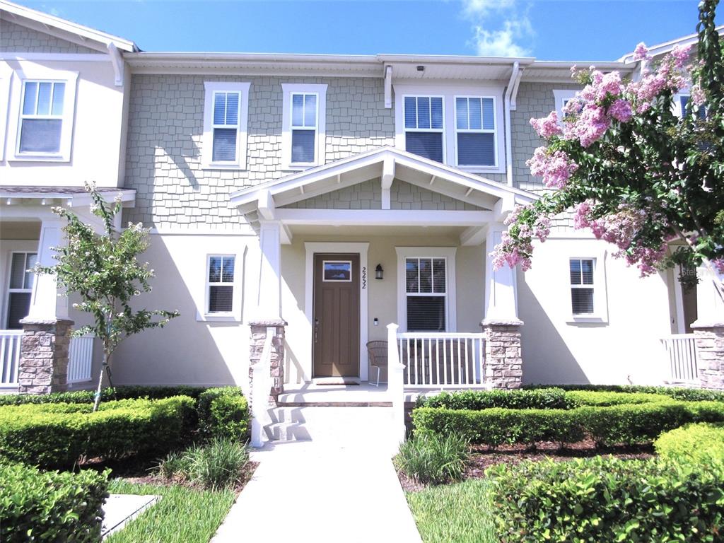 2252 Celebration Boulevard Celebration, FL 34747 - Photo 1 of 40 a front view of a house with a yard and outdoor seating