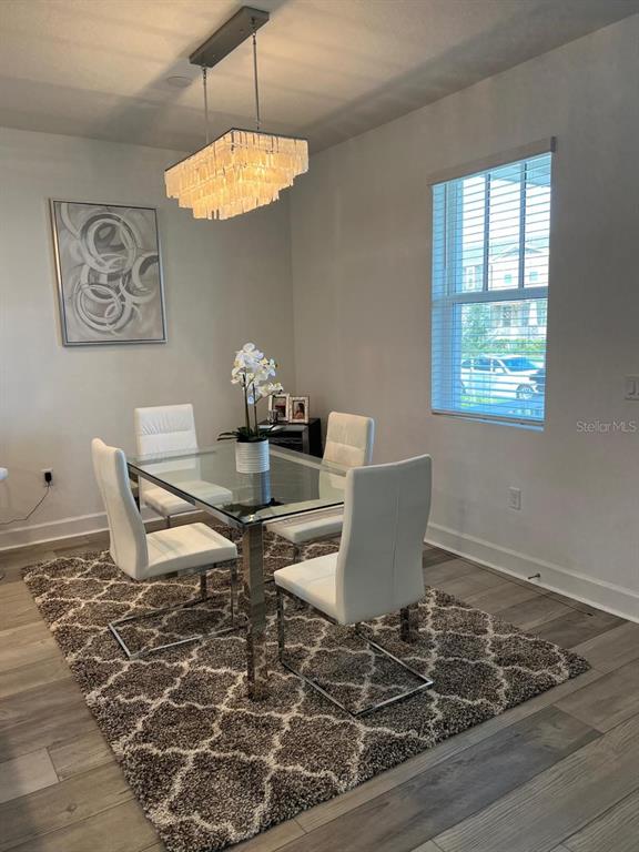 2252 Celebration Boulevard Celebration, FL 34747 - Photo 14 of 40 a view of a dining room with furniture a rug and wooden floor