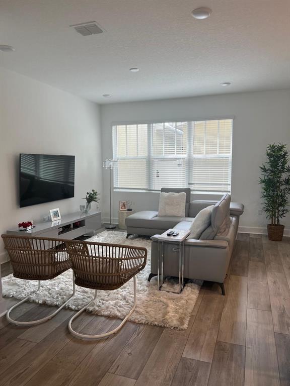 2252 Celebration Boulevard Celebration, FL 34747 - Photo 17 of 40 a living room with furniture and a flat screen tv