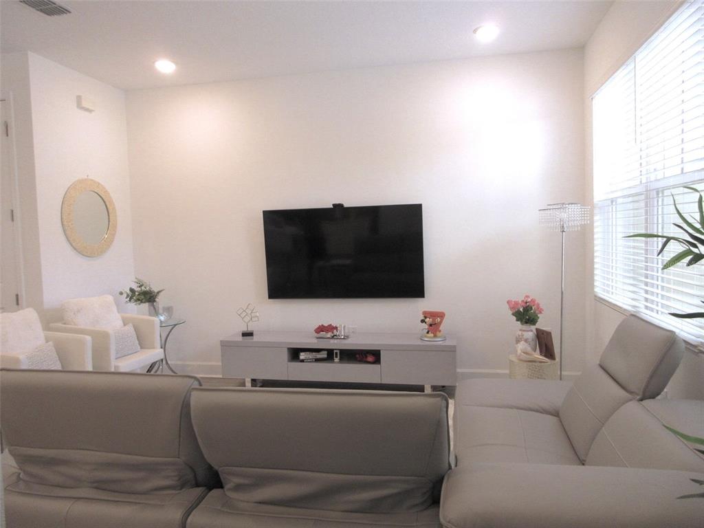 2252 Celebration Boulevard Celebration, FL 34747 - Photo 21 of 40 a living room with furniture and a flat screen tv