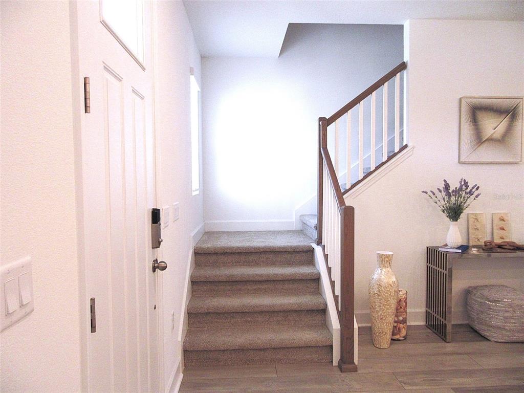 2252 Celebration Boulevard Celebration, FL 34747 - Photo 22 of 40 a view of staircase with white walls and a window