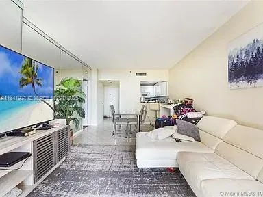 a dining room with furniture and kitchen view