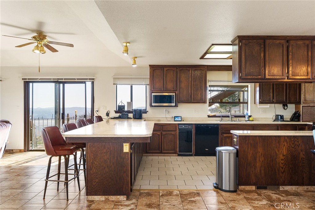 2114 Lumpkin Road Oroville, CA 95966 - Photo 5 of 25 a kitchen with stainless steel appliances kitchen island granite countertop a sink table and chairs