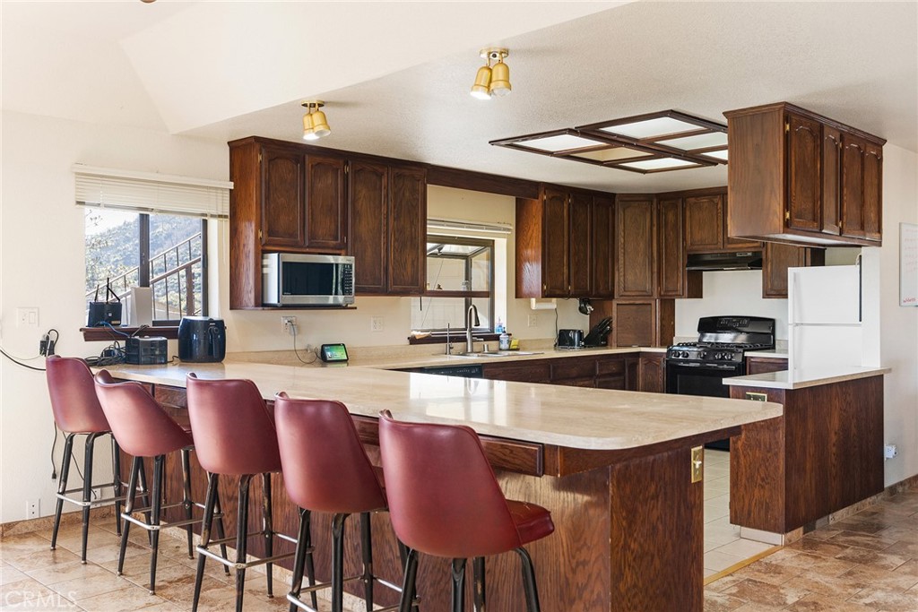 2114 Lumpkin Road Oroville, CA 95966 - Photo 6 of 25 a kitchen with stainless steel appliances kitchen island granite countertop a sink and cabinets