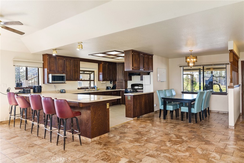 2114 Lumpkin Road Oroville, CA 95966 - Photo 9 of 25 a kitchen with a table chairs sink and cabinets
