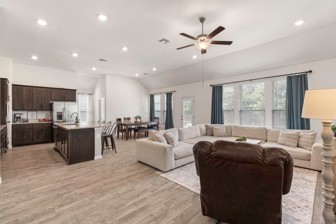 232 Silver Pass Kyle, TX 78640 - Photo 14 of 39 This bright and breezy living room is the real MVP of the hom open to the kitchen and dining, so you can cook, snack, and parent all at the same time. Massive windows let the sunshine pour in, while the vaulted ceiling and cozy layout make it perfect for movie marathons and Sunday naps!