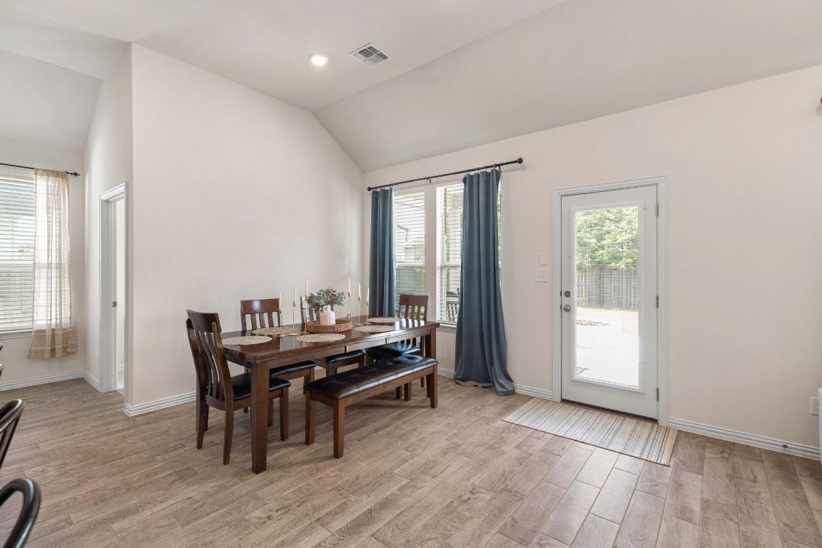 232 Silver Pass Kyle, TX 78640 - Photo 17 of 39 Surrounded by sunshine, the dining space blends everyday comfort with entertaining ease. Enjoy backyard views, airy vibes, and a layout that brings everyone to the table.