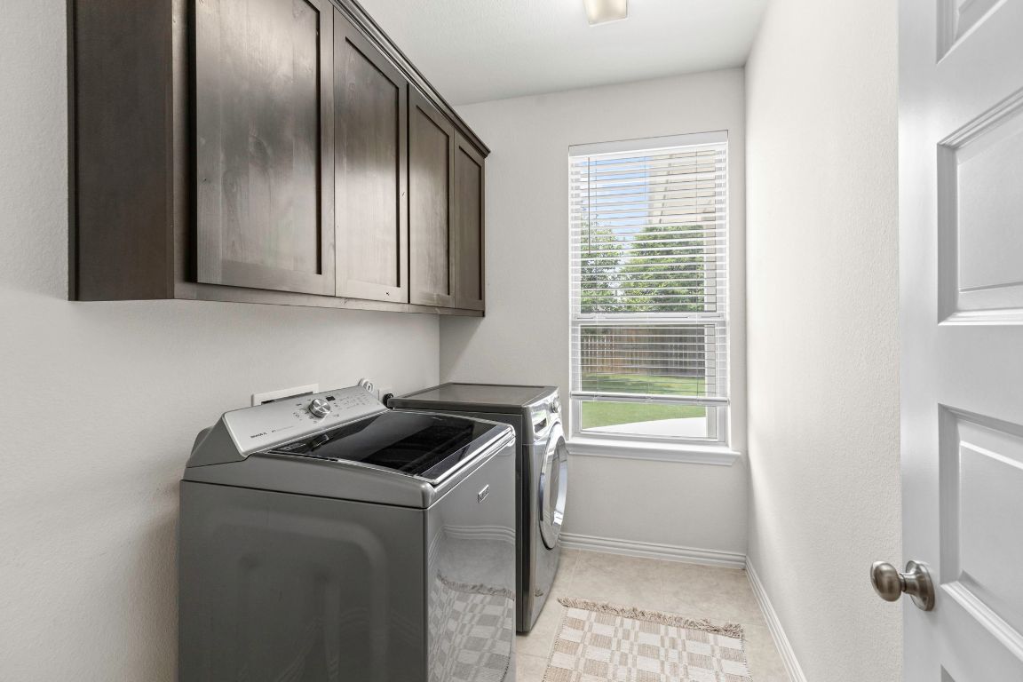 232 Silver Pass Kyle, TX 78640 - Photo 20 of 39 This bright laundry room makes chores almost enjoyable with upper cabinets for hiding the mess and natural light that says, “You’ve got this!” Whether it’s folding towels or hiding from responsibilities, this space is ready!