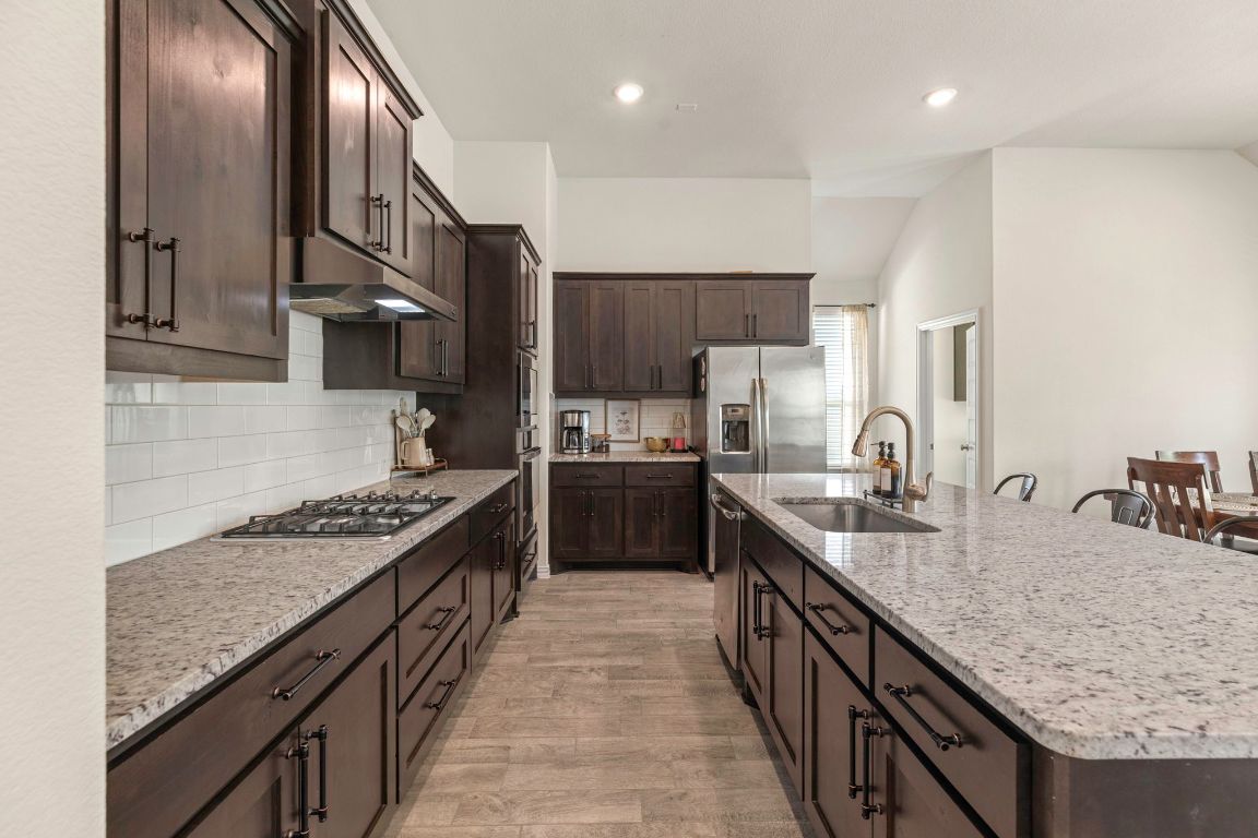 232 Silver Pass Kyle, TX 78640 - Photo 2 of 39 From the 4-burner gas cooktop to the deep undermount sink and wall oven, every inch of this chef’s kitchen is designed for cooking, hosting, and creating beautiful memories