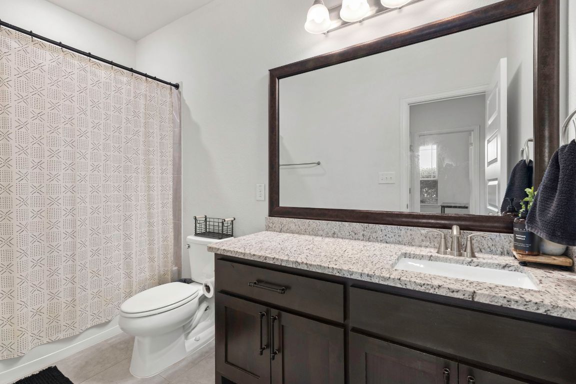 232 Silver Pass Kyle, TX 78640 - Photo 29 of 39 This full guest bathroom offers style and function with its granite countertop, espresso cabinetry, and large framed mirror. Neutral tile flooring, updated lighting, and a tub/shower combo make it a comfortable and convenient space for visitors or family