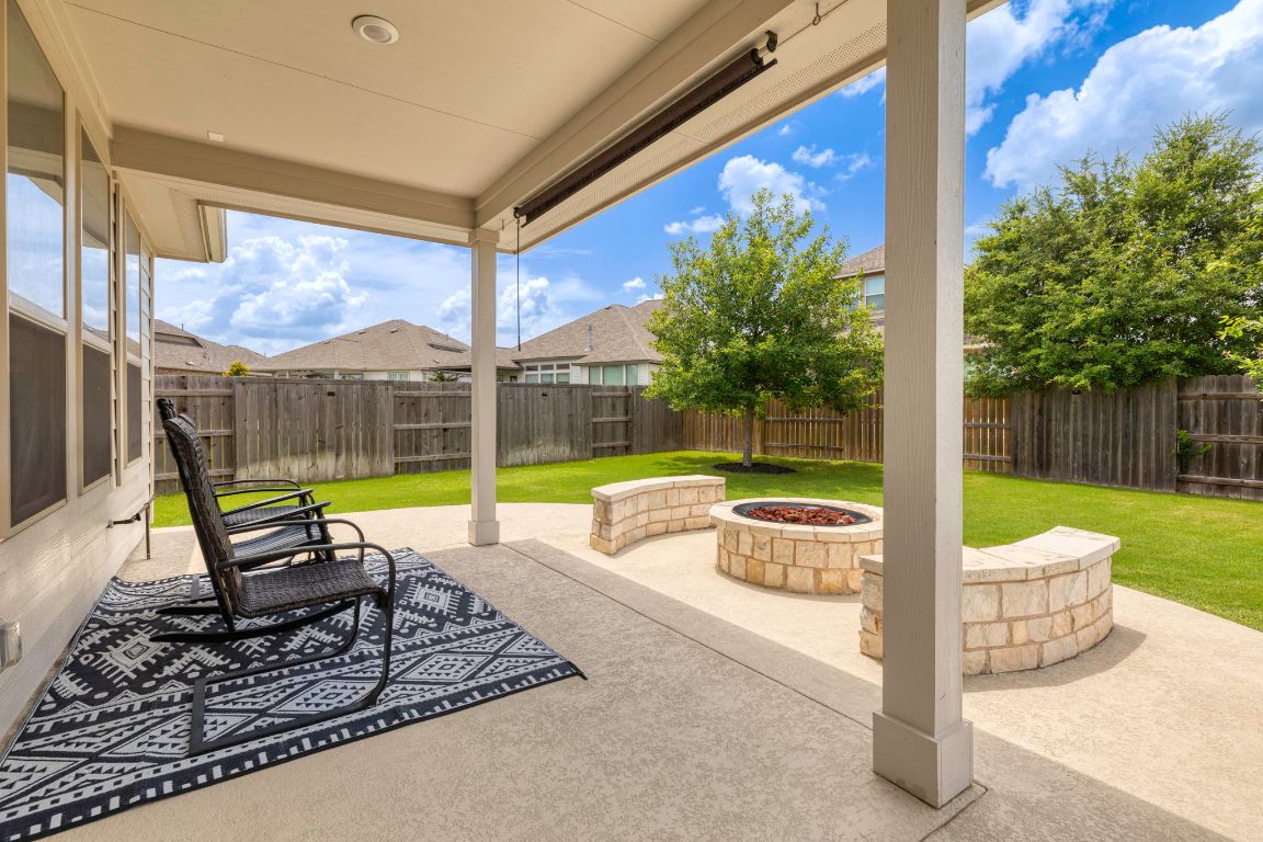 232 Silver Pass Kyle, TX 78640 - Photo 4 of 39 This covered back patio is built for Texas evenings complete with an extended concrete pad, stone fire pit with curved seating, and a built-in gas line ready for your dream grill setup. Relax under the shade or gather ‘round the fire, this space is ready to entertain year-round