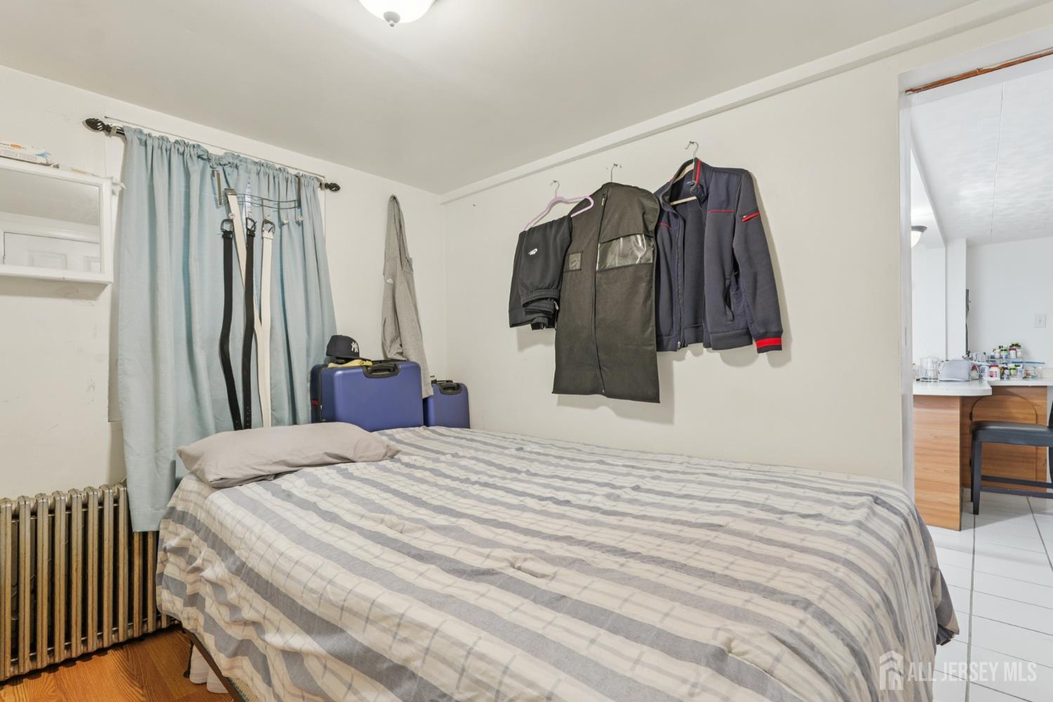 655 Charles Street Perth Amboy, NJ 08861 - Photo 11 of 29 a bed room with a bed and a closet