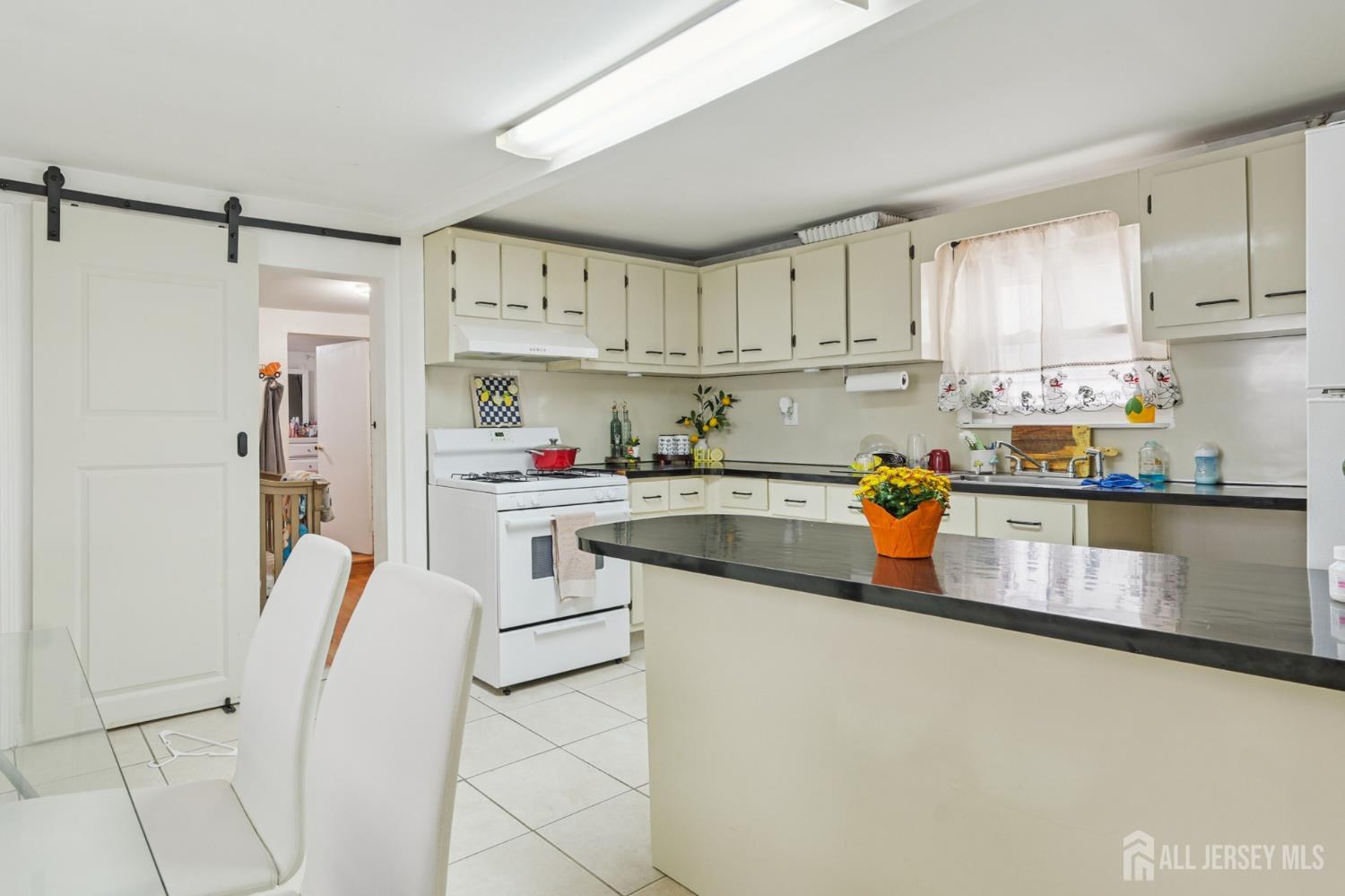 655 Charles Street Perth Amboy, NJ 08861 - Photo 18 of 29 a kitchen with cabinets and white appliances