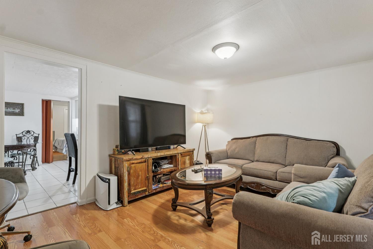 655 Charles Street Perth Amboy, NJ 08861 - Photo 2 of 29 a living room with furniture and a flat screen tv