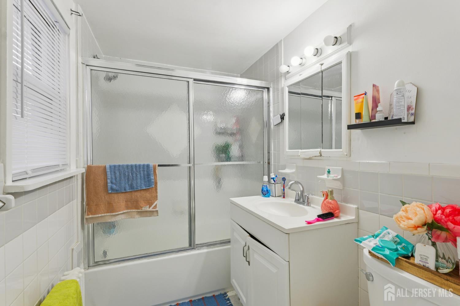 655 Charles Street Perth Amboy, NJ 08861 - Photo 23 of 29 a bathroom with a sink and a mirror