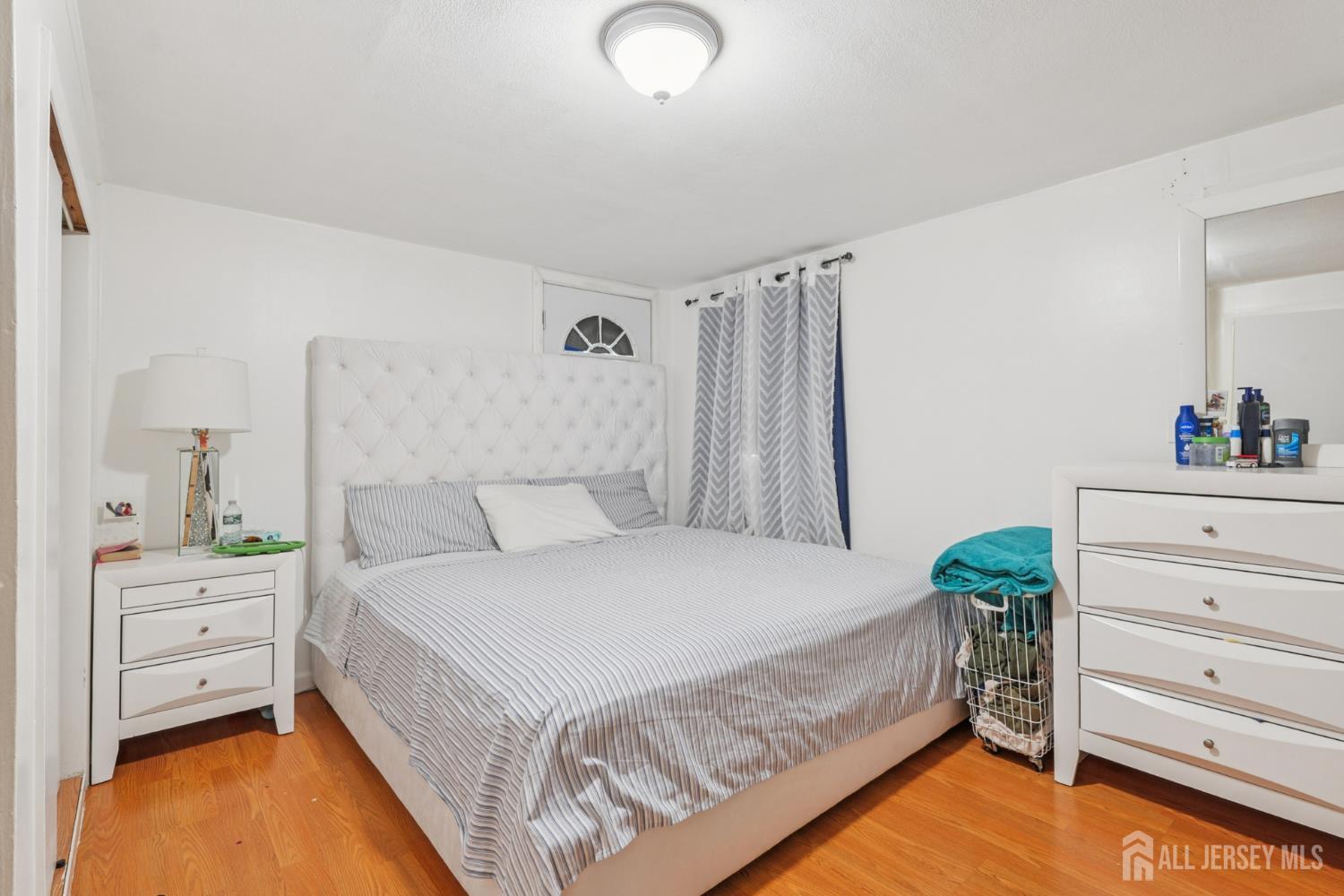 655 Charles Street Perth Amboy, NJ 08861 - Photo 26 of 29 a bedroom with a bed and a dresser