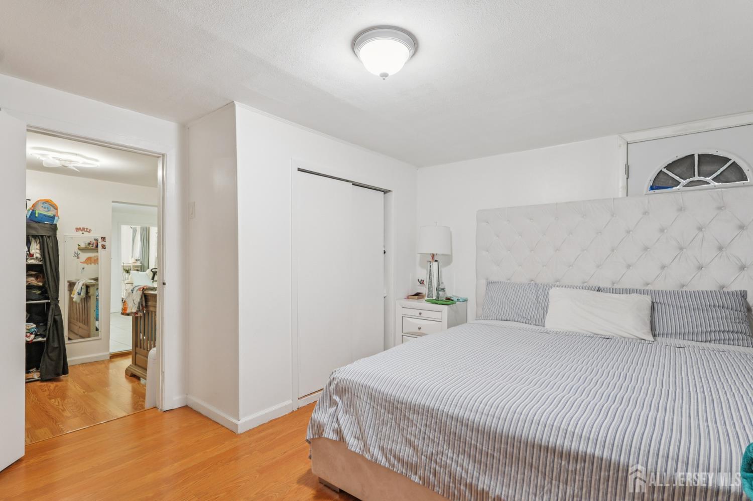 655 Charles Street Perth Amboy, NJ 08861 - Photo 27 of 29 a bedroom with a bed and a refrigerator