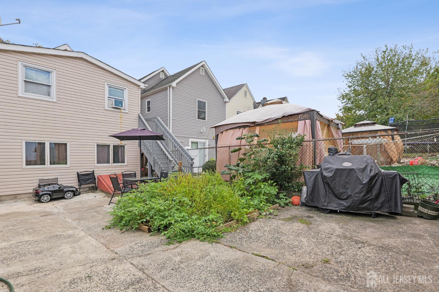 655 Charles Street Perth Amboy, NJ 08861 - Photo 28 of 29 a view of a house with a yard and sitting area